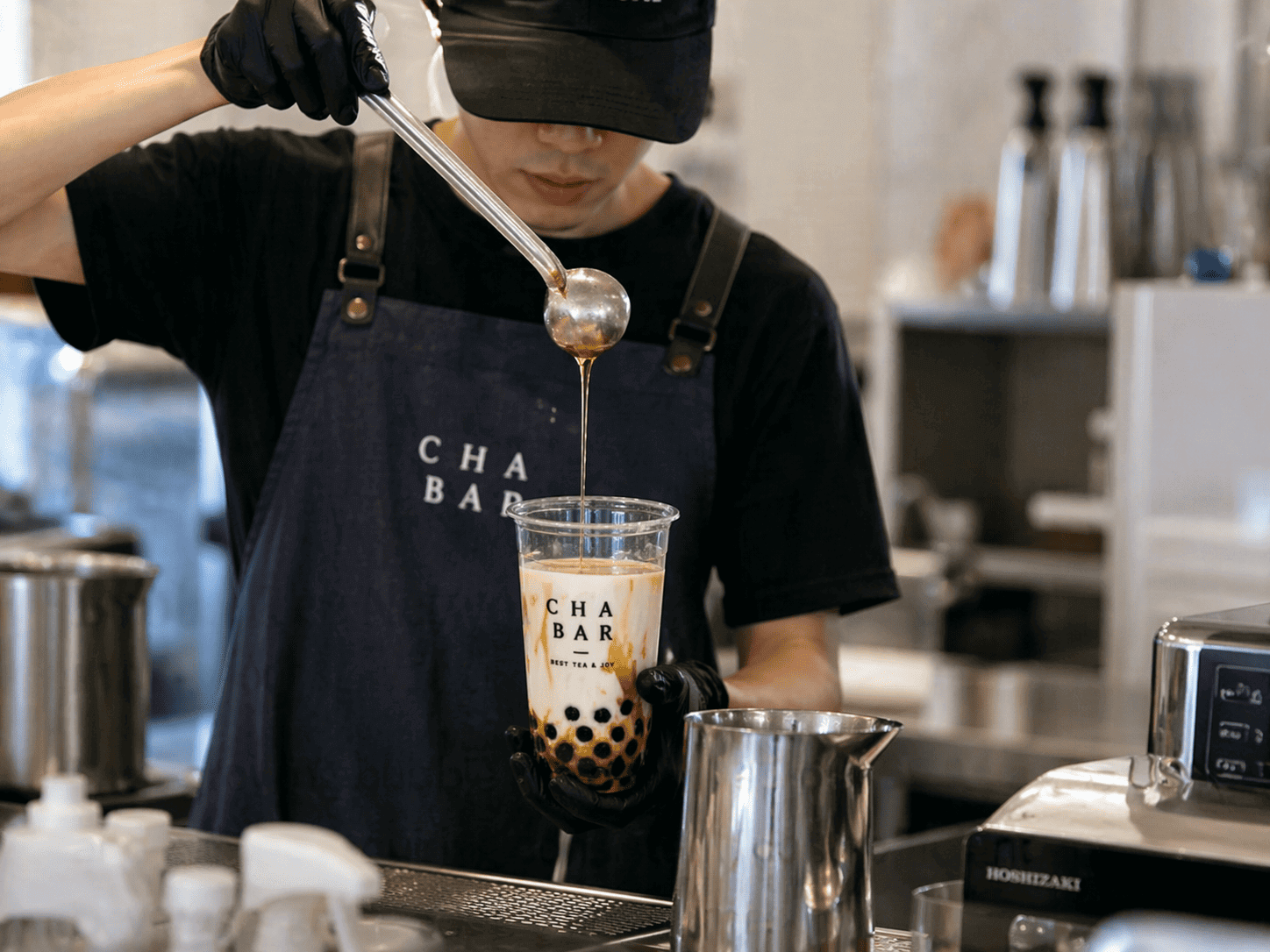Matcha drink preparation by barista showing real beverage production process in shop environment