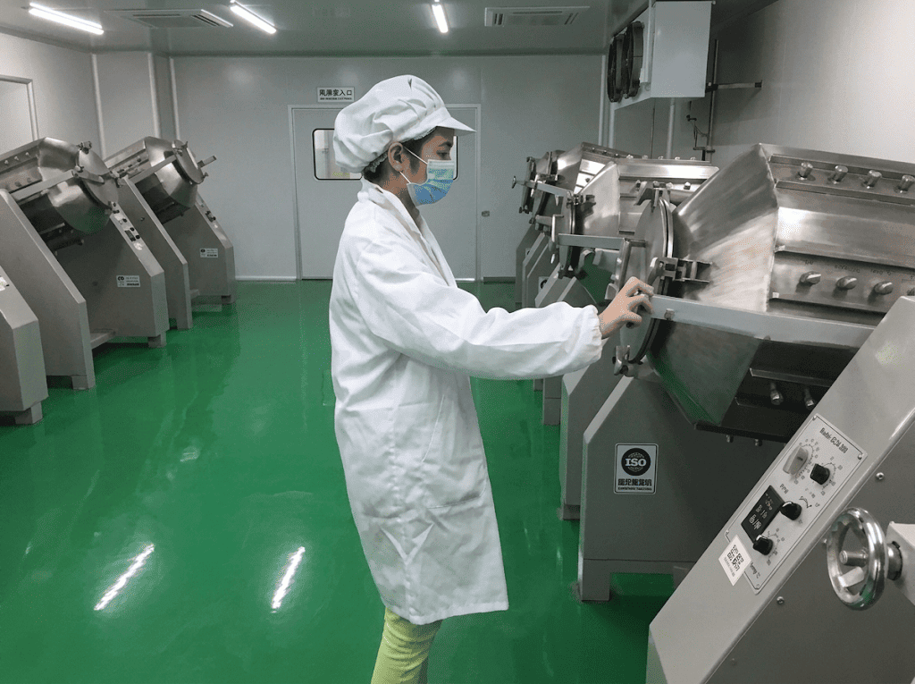 Matcha Processing Operation - Premium Bulk Matcha Powder Supplier from China. matcha powder production worker operating processing machine in clean workshop