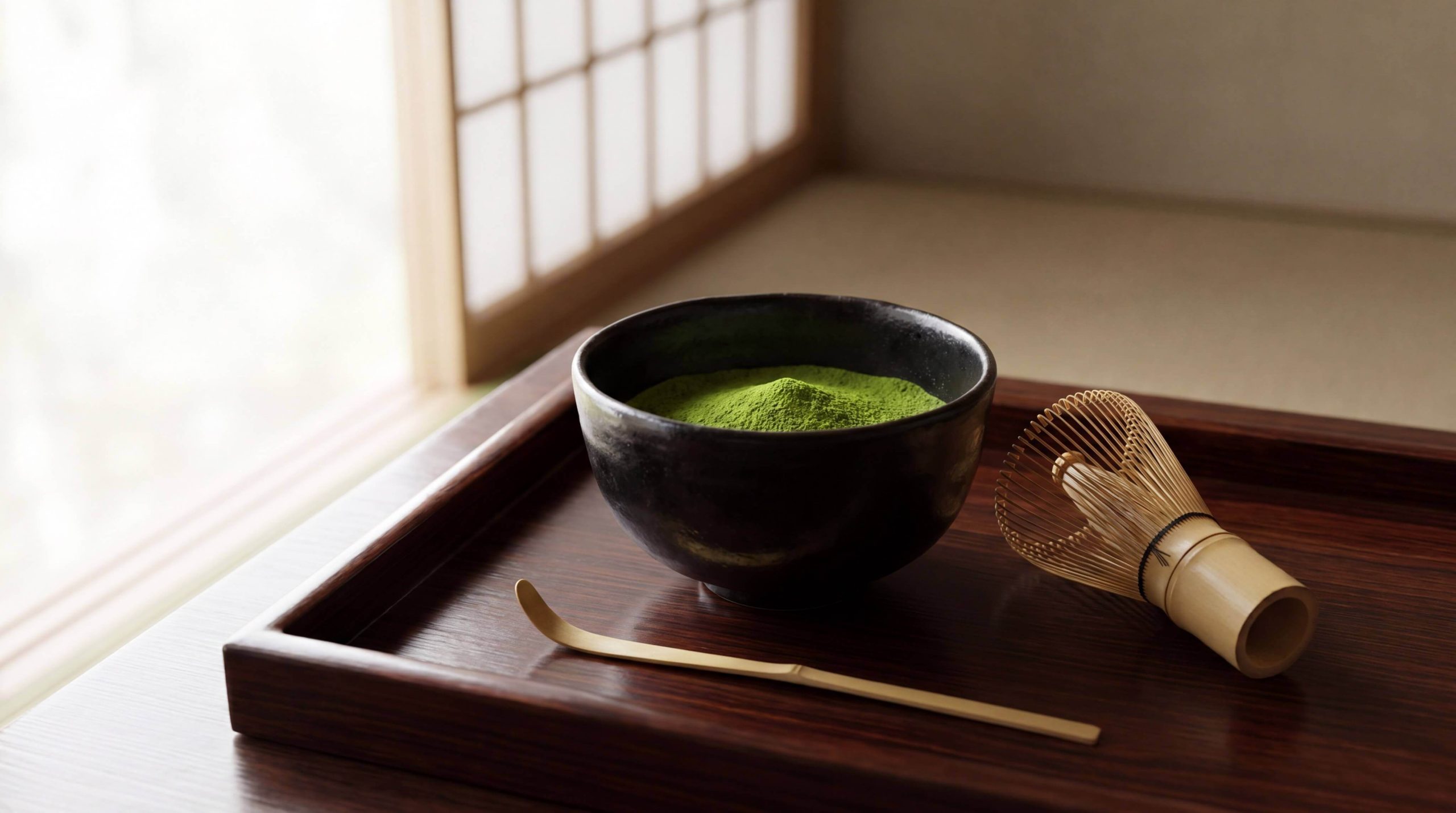 Traditional matcha tea set with bowl and whisk showing authentic preparation method
