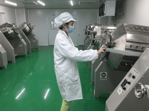 matcha powder production worker operating processing machine in clean workshop